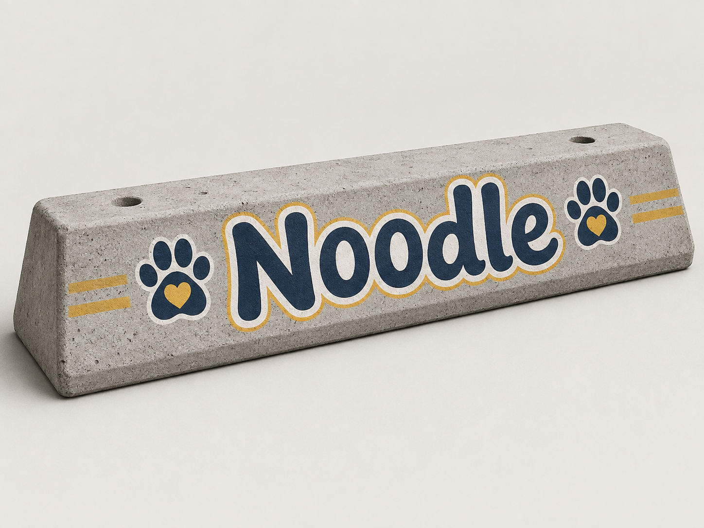 A concrete parking stop painted with the name Noodle and paw-print decorations
